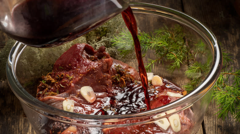 Steak marinating in glass bowl