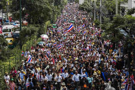 Anti-government protesters march during a rally at a major business district in Bangkok December 19, 2013. Anti-government protesters marched in Bangkok on Thursday in a bid to force Prime Minister Yingluck Shinawatra from office but their numbers appeared far smaller than earlier in the month, when she called a snap election to try to defuse the crisis. REUTERS/Athit Perawongmetha