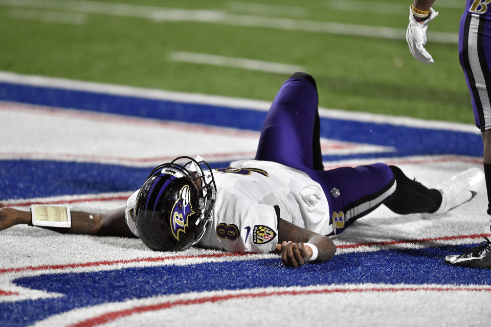 Baltimore Ravens quarterback Lamar Jackson (8) lies on the ground after being injured during the second half of an NFL divisional round football game against the Buffalo Bills Saturday, Jan. 16, 2021, in Orchard Park, N.Y. Jackson left the game after his injury. (AP Photo/Adrian Kraus)