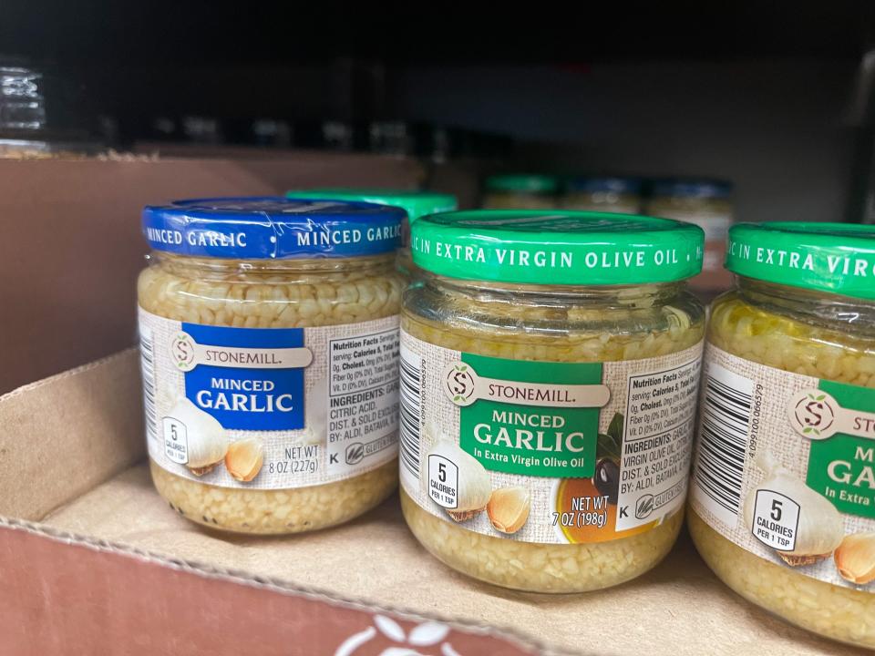 Jars of peeled and minced garlic in a cardboard box