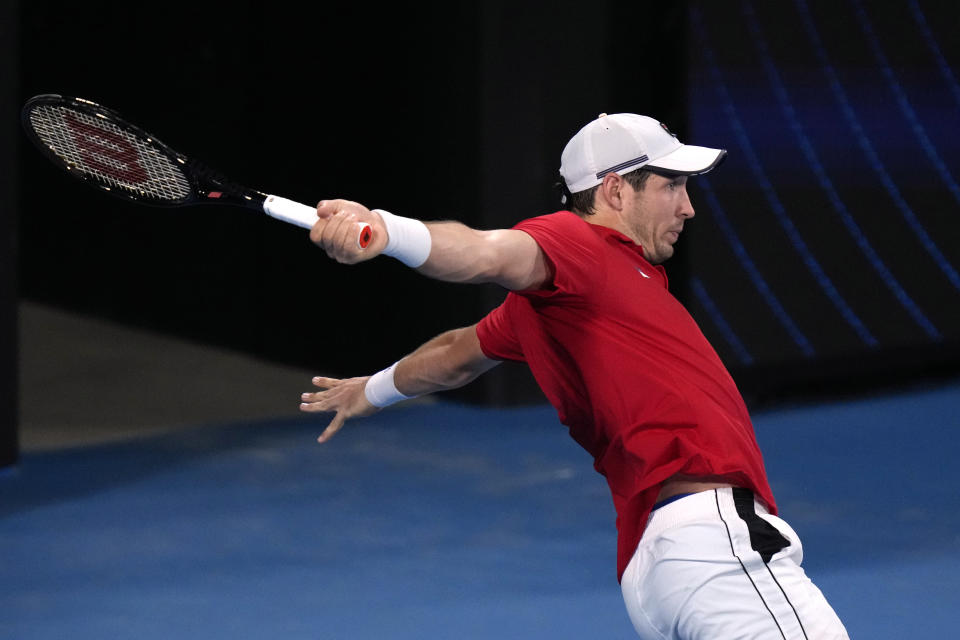 Serbia's Dusan Lajovic hits a backhand to Norway's Casper Ruud during their match at the ATP Cup tennis tournament in Sydney, Saturday, Jan. 1, 2022. (AP Photo/Rick Rycroft)