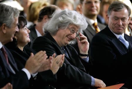 Hungarian writer Peter Esterhazy (C) smiles as he receives applause from German President Horst Koehler (R) and Germany's former minister of culture, Michael Naumann (L) prior to the presentation of the peace prize of the German bookseller association in Frankfurt's famous Paul's church, October 10, 2004. REUTERS/Kai Pfaffenbach