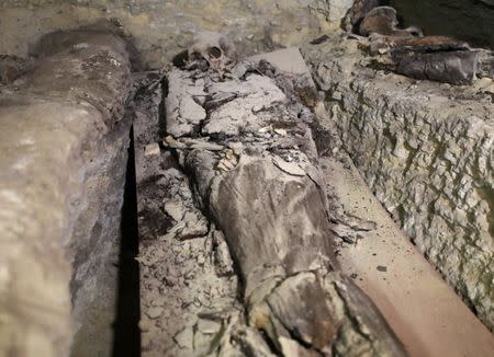 A mummy is seen inside the newly discovered burial site near Egypt's Saqqara necropolis, in Giza Egypt July 14, 2018. REUTERS/Mohamed Abd El Ghany