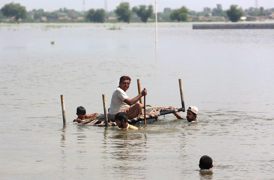 People use cots to salvage belongings from nearby flooded homes caused by heavy rain in Jaffarabad, a district of Pakistan's southwestern Baluchistan province, Saturday, Sep. 3, 2022. The homeless people affected by monsoon rains triggered devastating floods in Pakistan, getting enhancing international attention amid growing numbers of fatalities and homeless families across the country as the federal planning minister appealed to the international community for an immense humanitarian response for 33 million people.