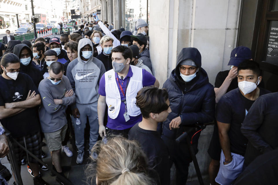 People queue outside the Niketown shop in London, Monday, June 15, 2020. After three months of being closed under coronavirus restrictions, shops selling fashion, toys and other non-essential goods are being allowed to reopen across England for the first time since the country went into lockdown in March.(AP Photo/Matt Dunham)