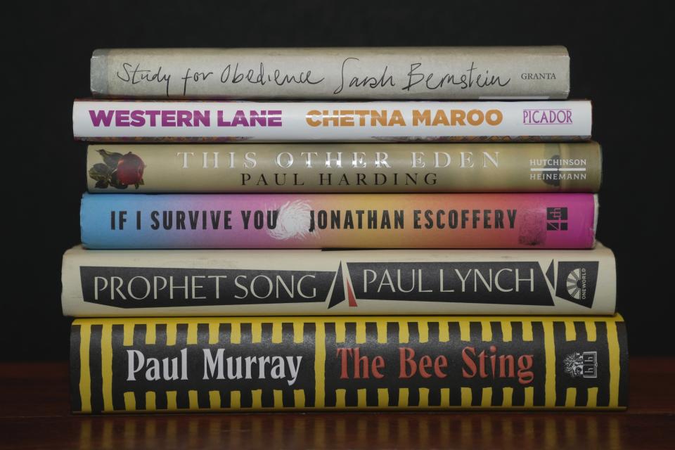 From top, the books "Study for Obedience", "Western Lane", "This Other Eden", "If I Survive You", "Prophet Song" and "The Bee Sting" are displayed during a photocall for the Booker Prize 2023, in London, Thursday, Nov. 23, 2023 ahead of the award ceremony on Nov. 26 in London. (AP Photo/Kin Cheung)