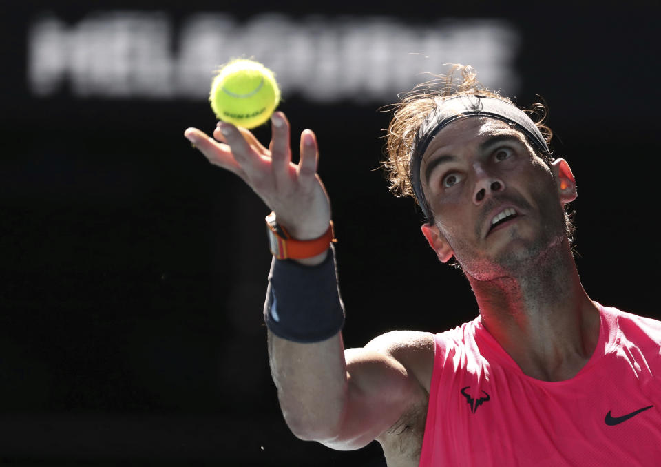 Spain's Rafael Nadal serves to compatriot Pablo Carreno Busta during their third round singles match at the Australian Open tennis championship in Melbourne, Australia, Saturday, Jan. 25, 2020. (AP Photo/Dita Alangkara)