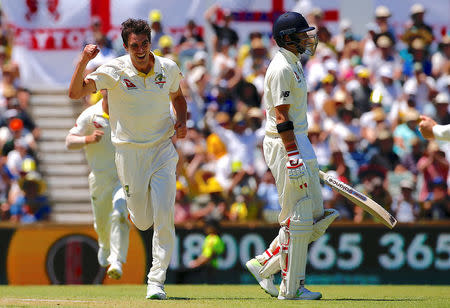 Cricket - Ashes test match - Australia v England - WACA Ground, Perth, Australia, December 14, 2017. England's captain Joe Root reacts as Australia's Pat Cummins celebrates his dismissal during the first day of the third Ashes cricket test match. REUTERS/David Gray