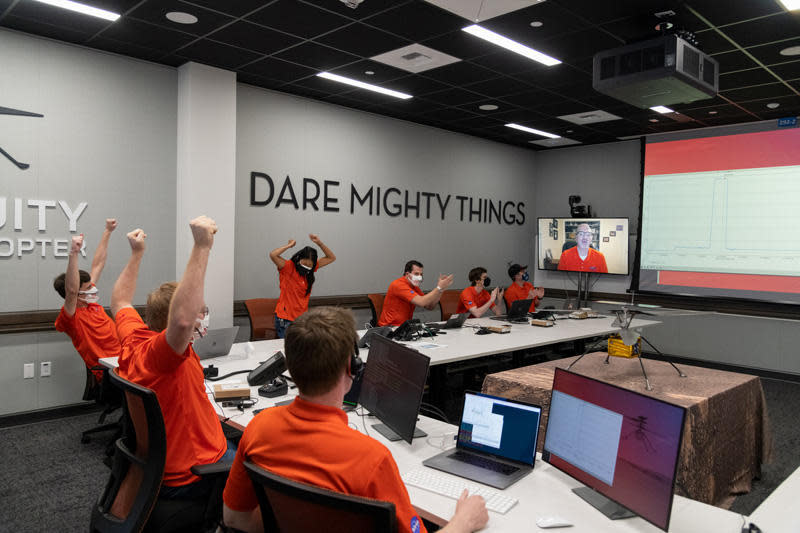 Ingenuity engineers at the Jet Propulsion Laboratory burst into applause as the first video comes in from Mars, showing the small helicopter flying in the thin martian atmosphere. Project manager MiMi Aung raises her fists in triumph standing under JPL's motto: 