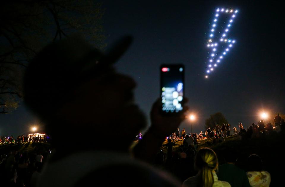 A lightning bolt made by drones hovers above the crowd in Clarksville before the start of the fireworks at the 2022 Thunder Over Louisville event.  April 23, 2022