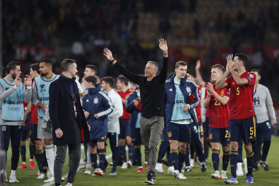 Spain's coach Luis Enrique, centre, celebrates at the end of the World Cup 2022 group B qualifying soccer match between Spain and Sweden at La Cartuja stadium in Seville, Spain, Sunday, Nov. 14, 2021. Spain defeated Sweden and qualify for the 2022 World Cup. (AP Photo/Angel Fernandez)