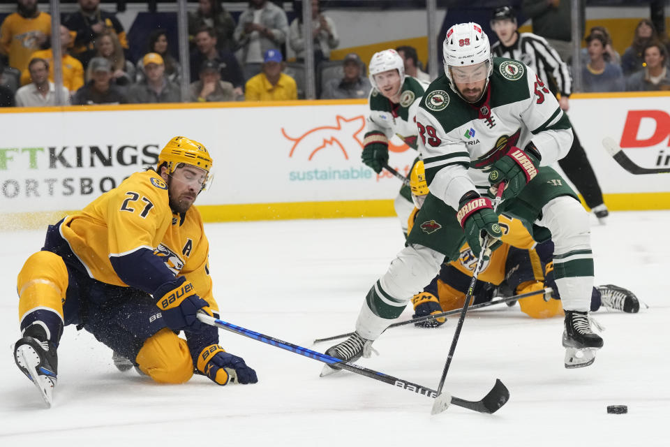 Minnesota Wild center Frederick Gaudreau (89) is defended by Nashville Predators' Ryan McDonagh (27) during the first period of an NHL hockey game Thursday, April 13, 2023, in Nashville, Tenn. (AP Photo/Mark Humphrey)