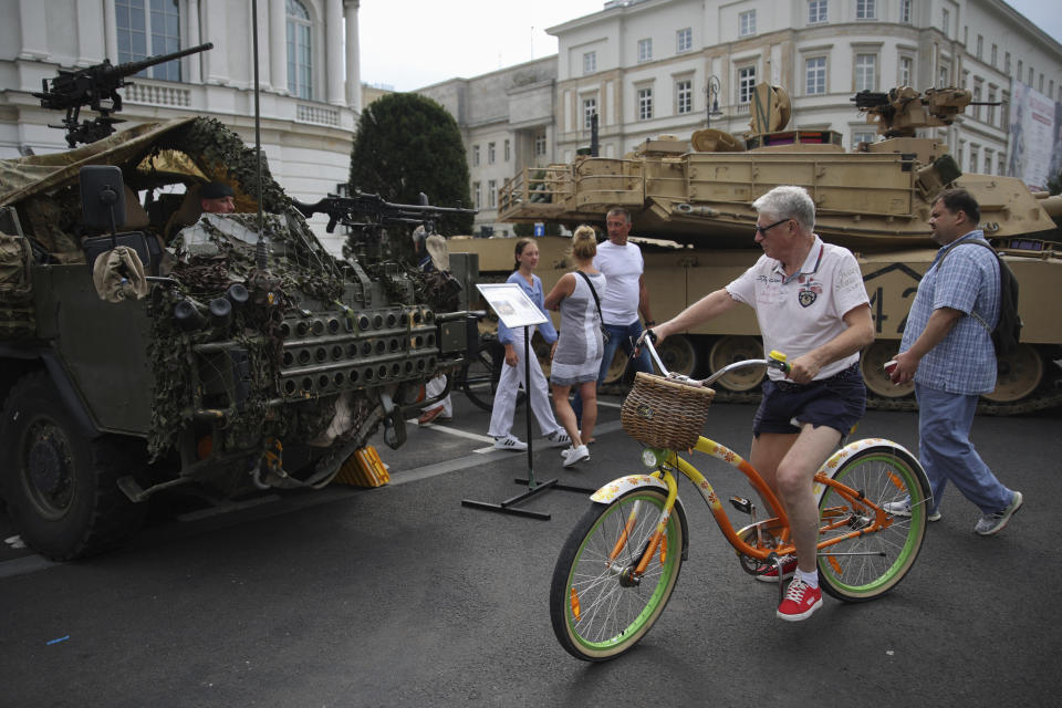 People attend a military picnic marking the Polish Army Day in Warsaw, Poland, Monday, Aug. 15, 2022. The Polish president and other officials marked their nation's Armed Forces Day holiday Monday alongside the U.S. army commander in Europe and regular American troops, a symbolic underlining of NATO support for members on the eastern front as Russia wages war nearby in Ukraine. (AP Photo/Michal Dyjuk)