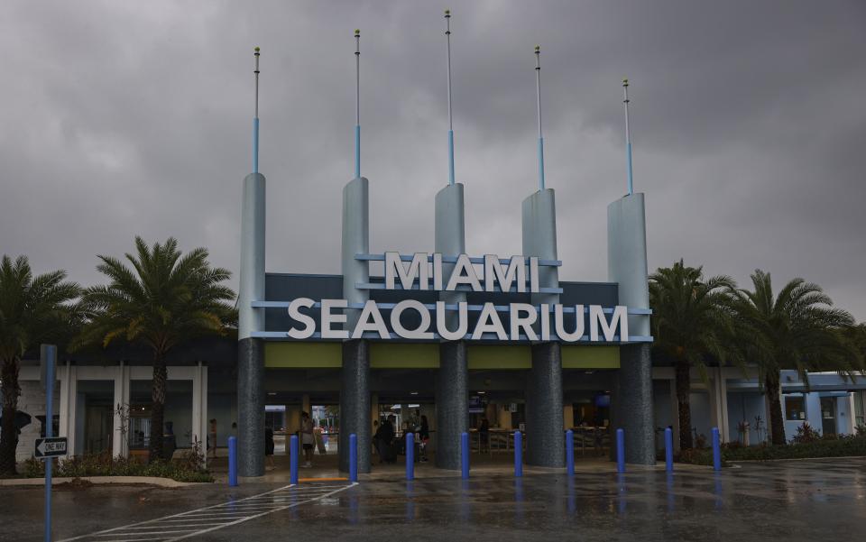 The entrance to Miami Seaquarium is seen, Thursday, March 30, 2023, in Miami. An unlikely coalition of a theme park owner, animal rights group and NFL owner-philanthropist announced Thursday that a plan is in place to return Lolita, an orca that has lived at the Miami Seaquarium for more than 50 years, to her home waters in the Pacific Northwest. (Alie Skowronski/Miami Herald via AP)