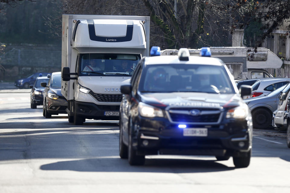 Italian Carabinieri police escort a refrigerated truck carrying a first batch of COVID-19 vaccines by drug company Moderna arriving at the Superior Health Institute, in Rome, Tuesday, Jan. 12, 2021. The drugs agency for the 27-nation EU has approved two coronavirus vaccines, one made by American drugmaker Pfizer and Germany's BioNTech and another by Moderna. (Cecilia Fabiano/LaPresse via AP)