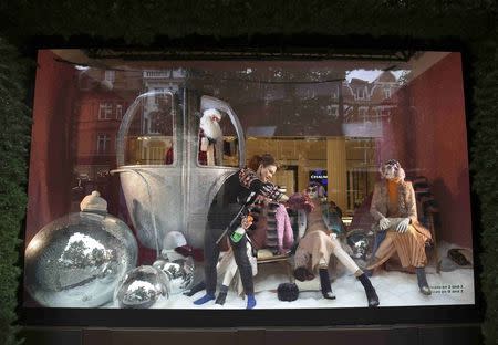 A worker adjusts a Christmas window display at a Selfridges store on Oxford Street in London, Britain October 20, 2016. REUTERS/Neil Hall