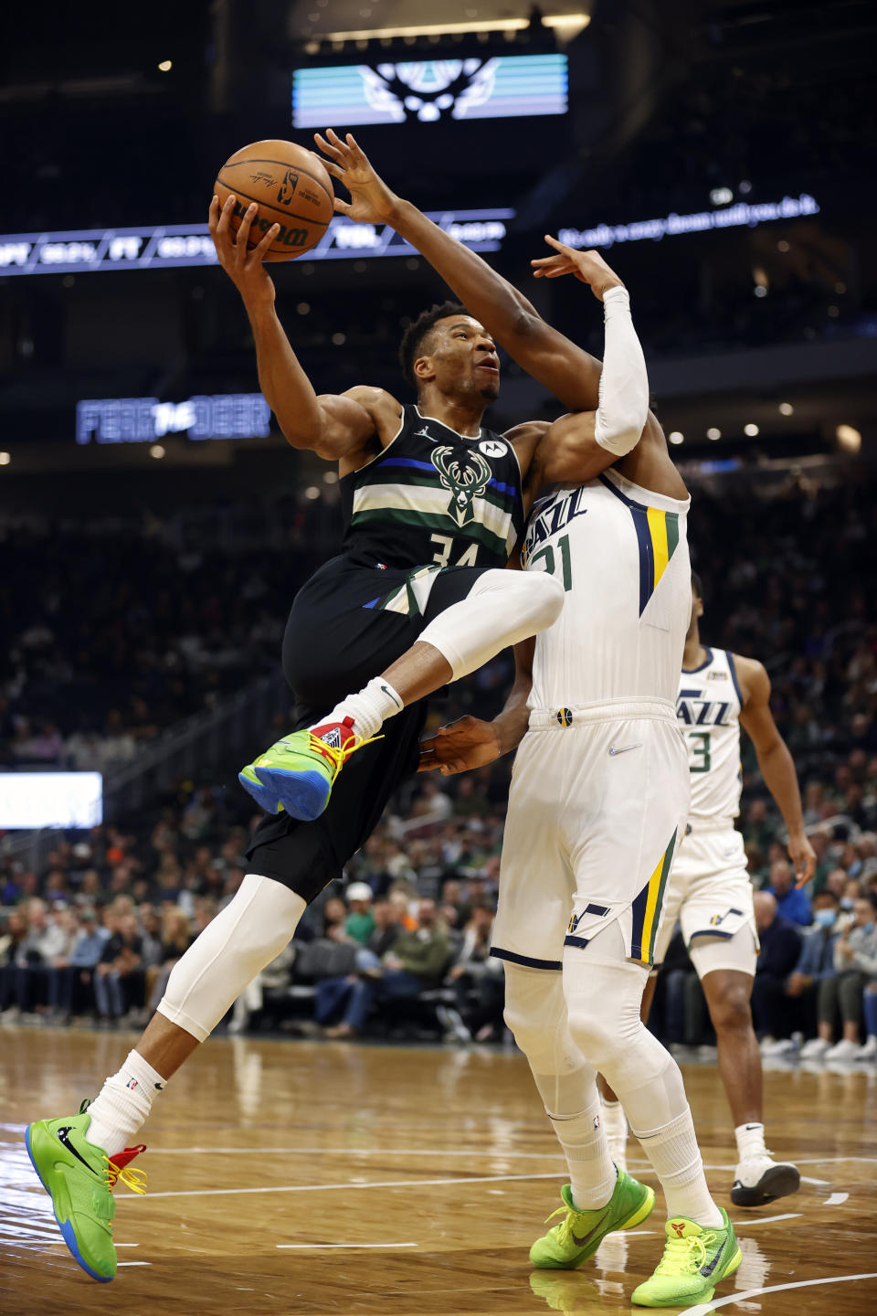 Milwaukee Bucks forward Giannis Antetokounmpo (34) drives against Utah Jazz center Hassan Whiteside (21) during the first half of an NBA basketball game Sunday, Oct. 31, 2021, in Milwaukee. (AP Photo/Jeffrey Phelps)