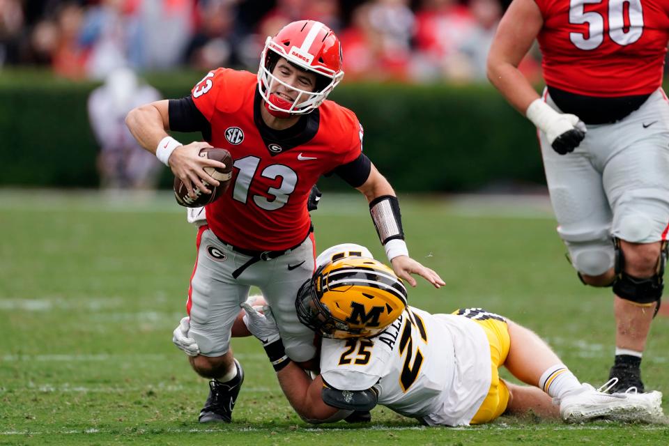 Georgia quarterback Stetson Bennett (13) is stopped by Missouri linebacker Blaze Alldredge (25) in the first half of a game Nov. 6 in Athens, Ga.