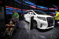 Visitors walk around a Toyota Alphard presented during the Auto China 2016 auto show in Beijing, China May 4, 2016. REUTERS/Jason Lee