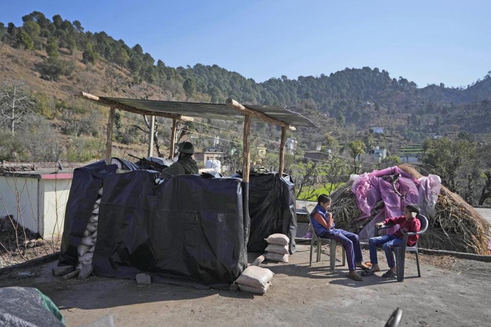 An Indian paramilitary soldier guards at Dhangri Village, in Rajouri, India, Tuesday, Feb. 7, 2023. Days after seven Hindus were killed in the village in disputed Kashmir, Indian authorities revived a government-sponsored militia and began rearming and training villagers. The militia, officially called the “Village Defense Group,” was initially formed in the 1990s as the first line of defense against anti-India insurgents in remote villages that government forces could not reach quickly. (AP Photo/Channi Anand)