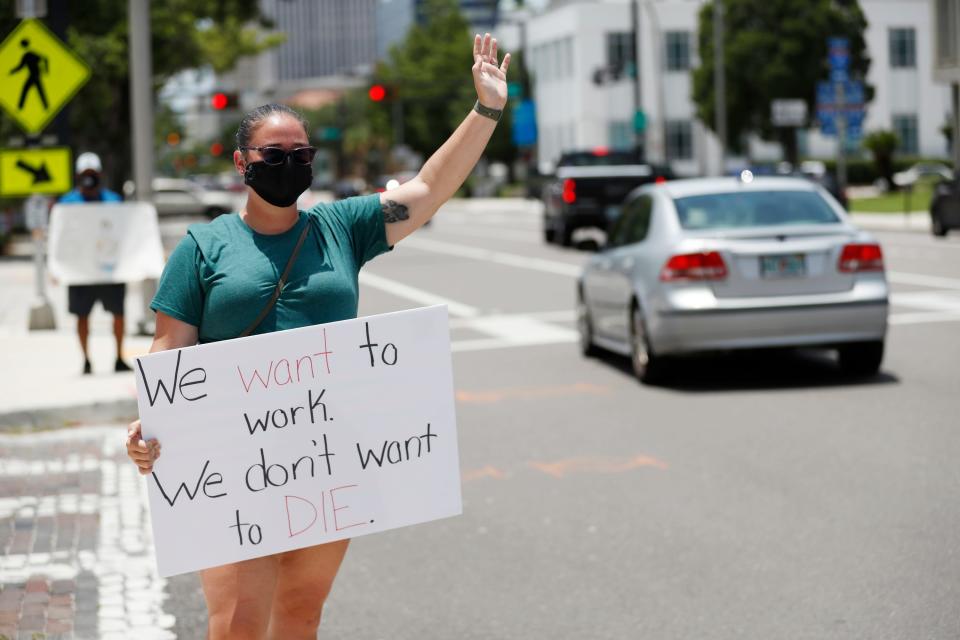 Middle school teacher Danielle Weigand stands in protest in front of the Hillsborough County Schools District Office on July 16, 2020, in Tampa, Fla. Teachers and administrators from Hillsborough County Schools rallied against the reopening of schools due to health and safety concerns amid the COVID-19 pandemic.