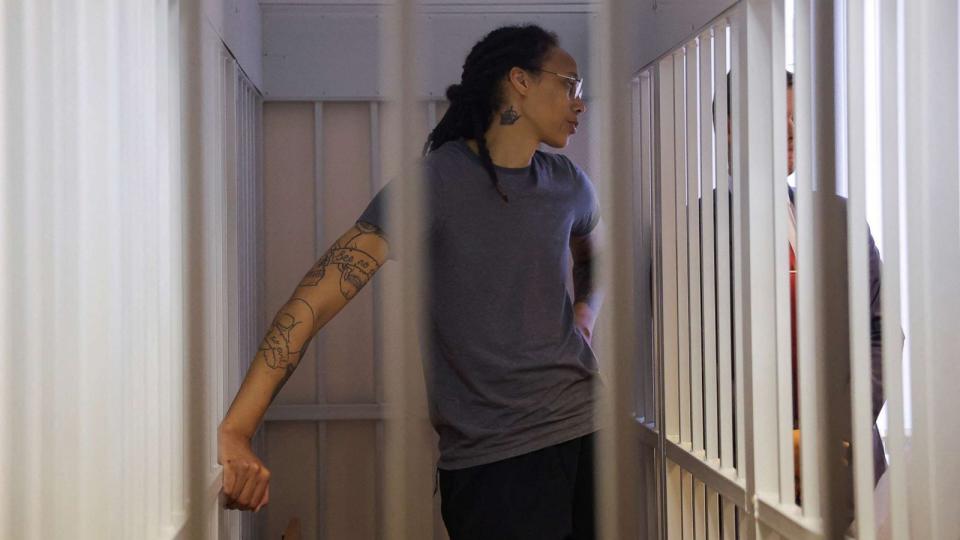PHOTO: Brittney Griner stands inside a defendants' cage during the reading of the court's verdict in Khimki, Russia, Aug. 4, 2022. (Evgenia Novozhenina/POOL via Reuters)