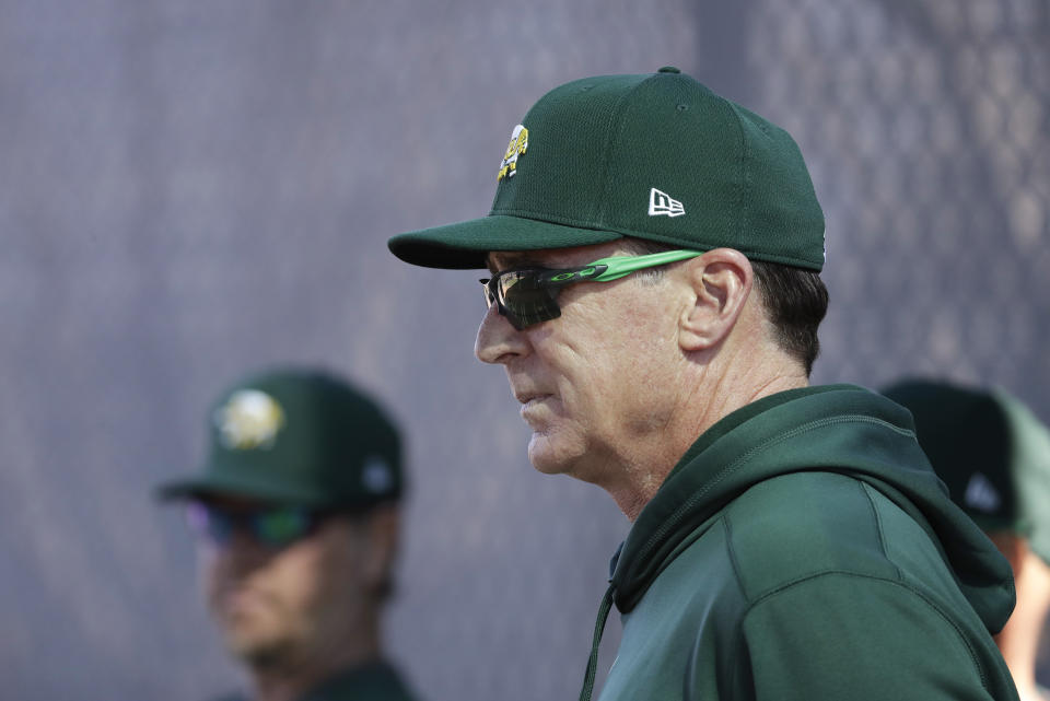 Oakland Athletics manager Bob Melvin watches as pitchers throw during spring training baseball, Wednesday, Feb. 12, 2020, in Mesa, Ariz. (AP Photo/Darron Cummings)