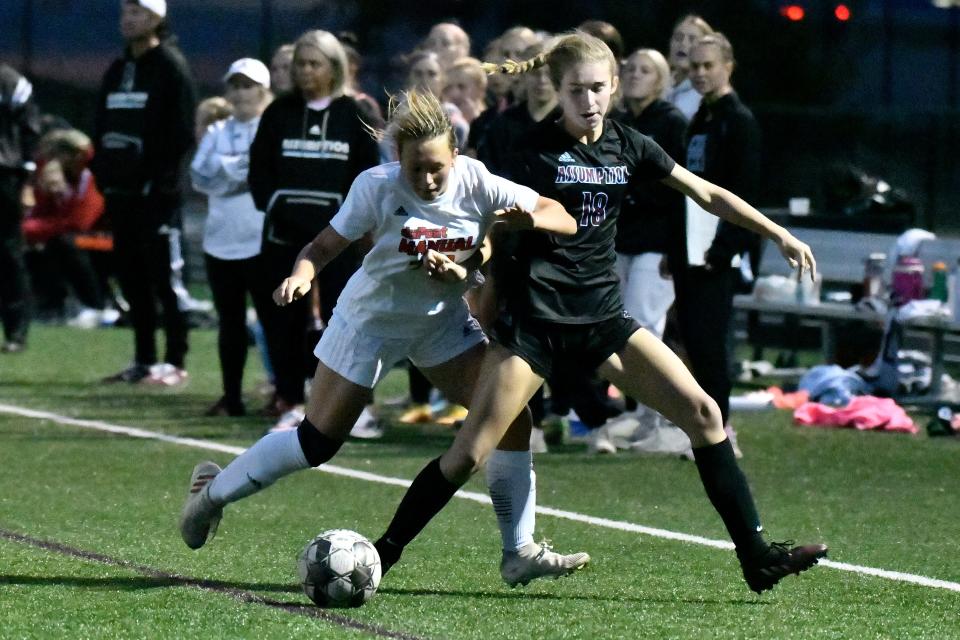 Manual's Lola Thompson (24) battles Assumption's Lilly Bovine (18) for the ball during the championship game of the 7th Region girls soccer tournament, Saturday, Oct. 15, 2022 in Louisville Ky. Assumption defeated Manual 4-1.