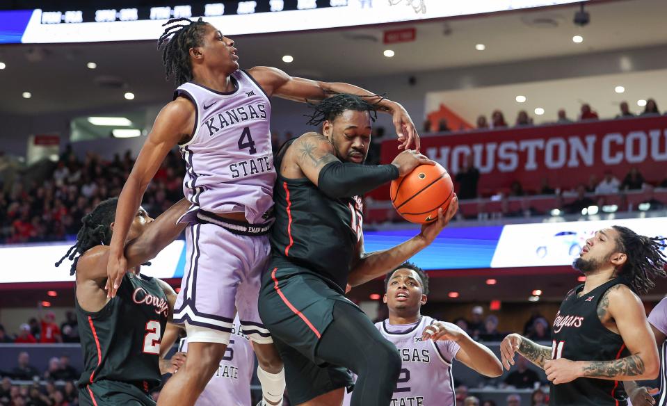 Houston forward J'Wan Roberts (13) snags a rebound away from Kansas State's Dai Dai Ames (4) during their game Saturday at Fertitta Center in Houston.