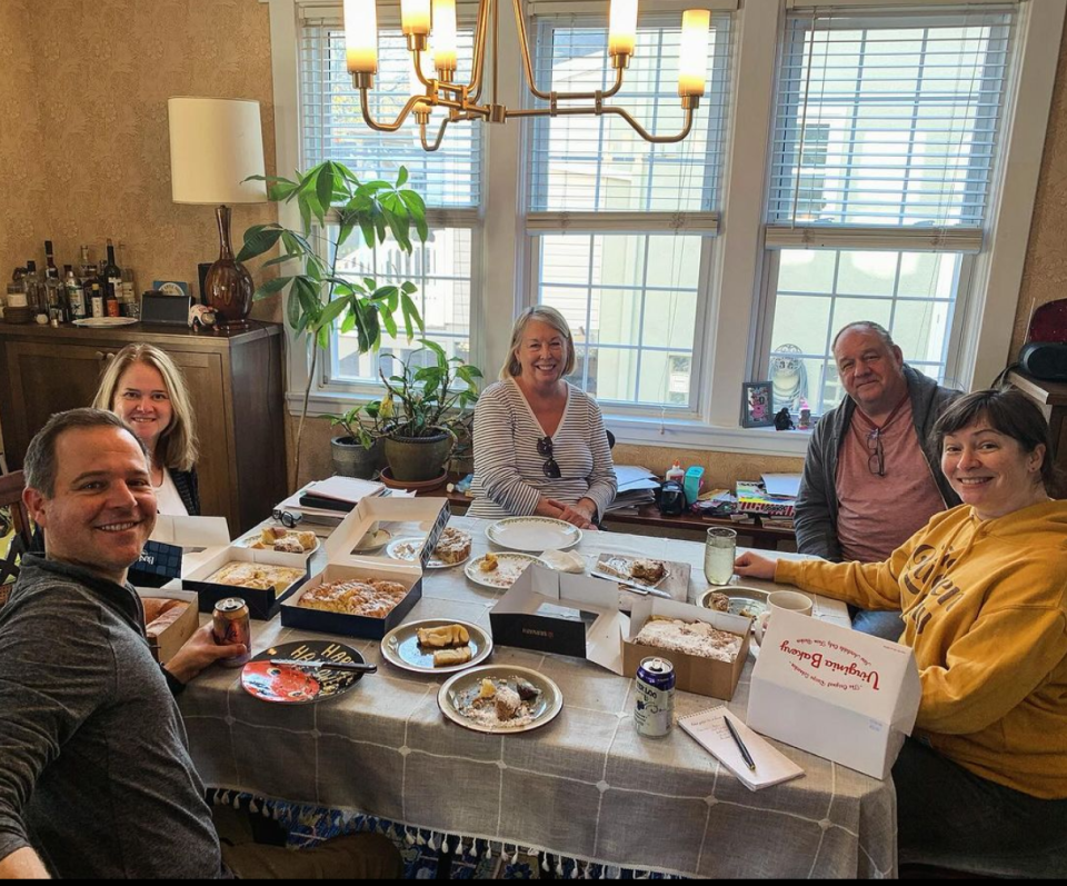 Keith's neighbors gather around the table for a coffeecake tasting.