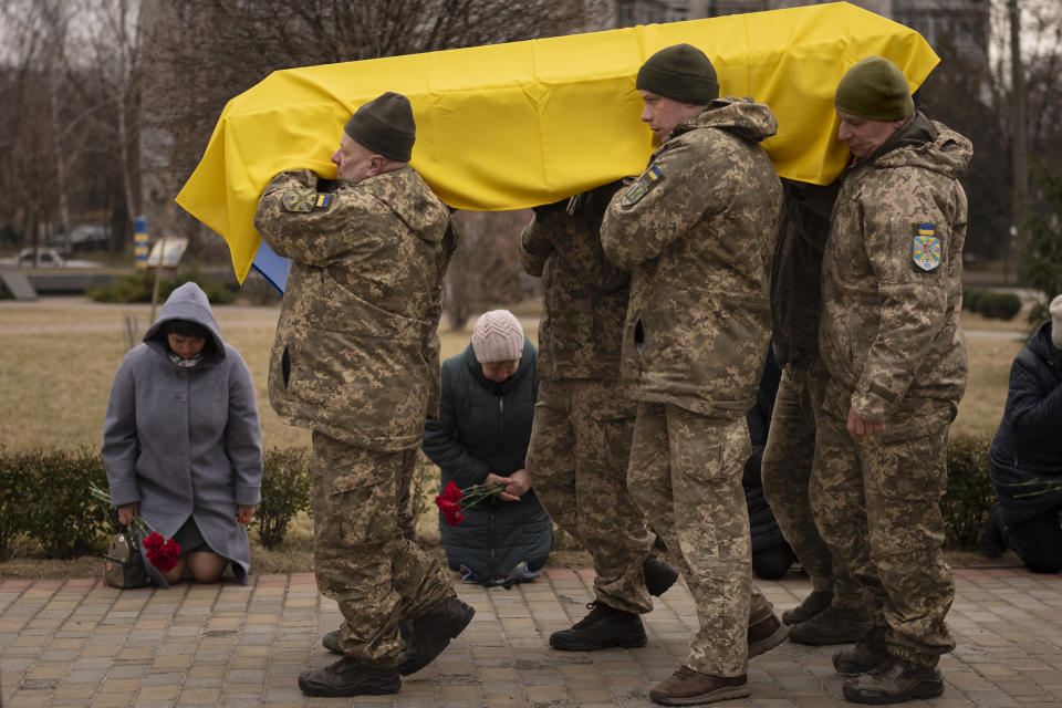 Ukrainian servicemen carry the coffin of Volodymyr Hurieiev, a fellow soldier killed in the Bakhmut area, during the funeral in Boryspil, Ukraine, Saturday, March 4, 2023. Pressure from Russian forces mounted Saturday on Ukrainians hunkered down in Bakhmut, as residents attempted to flee with help from troops who Western analysts say may be preparing to withdraw from the key eastern stronghold. (AP Photo/Vadim Ghirda)