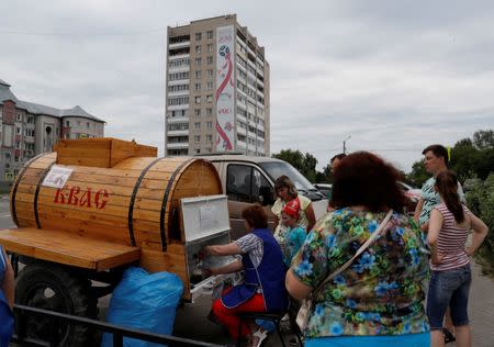 A woman sells Kvas at a street market in Bor, Nizhny Novgorod, Russia July 1, 2018. REUTERS/Darren Staples