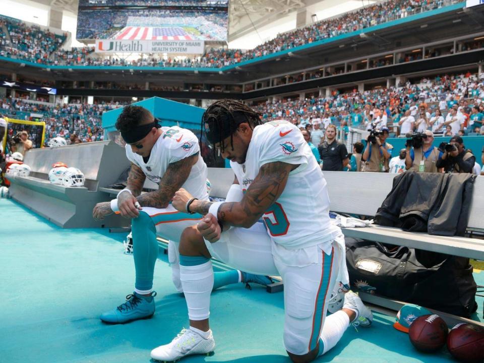 Kenny Stills and Albert Wilson protest during the national anthem (AP)