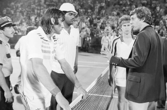 <p>Bettmann Archive</p> Tennis official reprimands Nastase while John McEnroe (background) watches on
