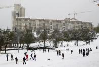 People visit a park after a snowstorm in Jerusalem December 12, 2013. Snow fell in Jerusalem and parts of the occupied West Bank where schools and offices were widely closed and public transport was paused. REUTERS/Amir Cohen (JERUSALEM - Tags: ENVIRONMENT)