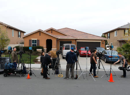 Members of the news media stand outside the home of David Allen Turpin and Louise Ann Turpin in Perris, California, U.S. January 15, 2018. REUTERS/Mike Blake
