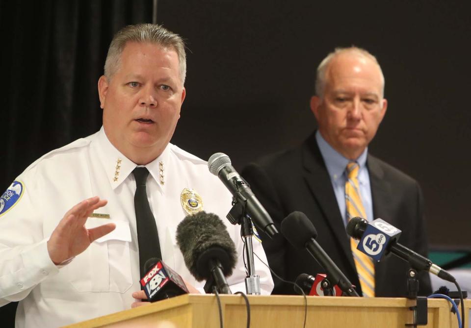 Akron Police Chief Steve Mylett speaks during Sunday's press conference as Mayor Dan Horrigan looks on.