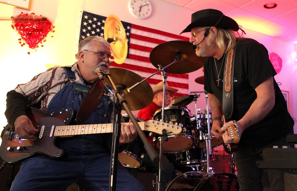 Little Mountain Band guitar player Jack Fish, left, and Robbie Robertson jam during the Little Mountain Band's first set Saturday at the Mitchell Senior Center. Drummer Wayne Bullington is in the background.