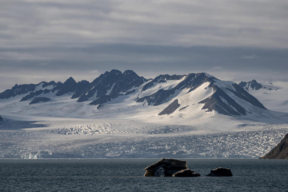 Image: Sea ice and large mountains with snow near Svalbard and Jan Mayen on July 23. (Sebnem Coskun / Anadolu Agency via Getty Images file)