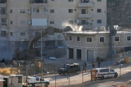 Israeli machinery demolishes a Palestinian building on the outskirts of Jerusalem