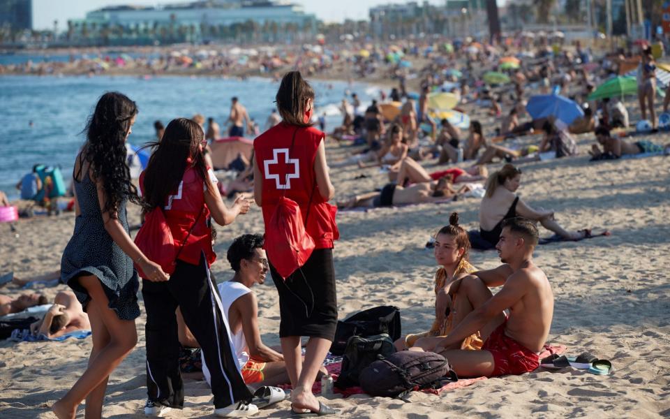 Spanish Red Cross members take part in a campaign to raise awareness among young people to avoid further spread of the coronavirus COVID-19 virus in Barcelona, Catalonia, Spain, 07 August 2020. - Shutterstock