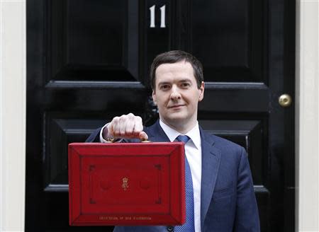 Britain's Chancellor of the Exchequer, George Osborne, holds up his budget case for the cameras as he stands outside number 11 Downing Street, before delivering his budget to the House of Commons, in central London March 19, 2014. REUTERS/Suzanne Plunkett