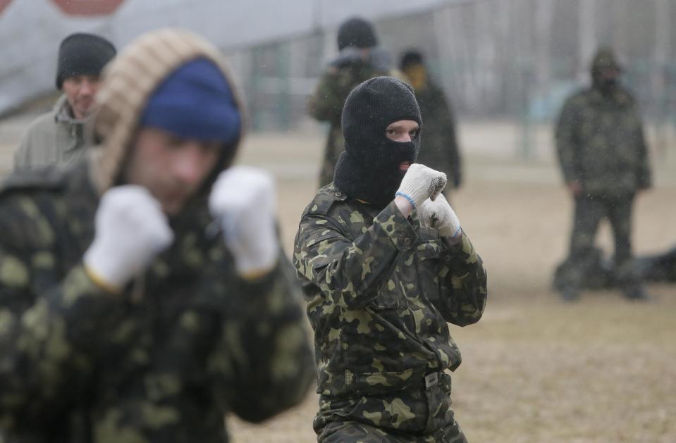 Self-Defense activists perform military exercises at a military training ground outside Kiev, Ukraine, Monday, March 17, 2014. Ukraine's parliament on Monday voted partial mobilization in response to Russia's invasion onto the Ukrainian territory. (AP Photo/Efrem Lukatsky)