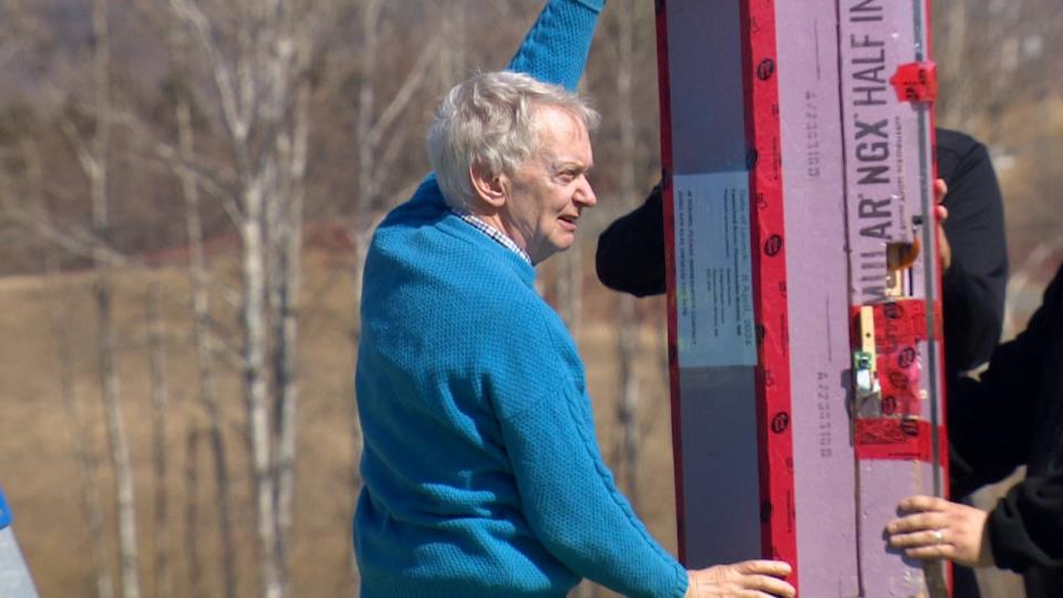 Retired scientist David Hunter holds the payload, containing computers and cameras, ahead of its launch. 