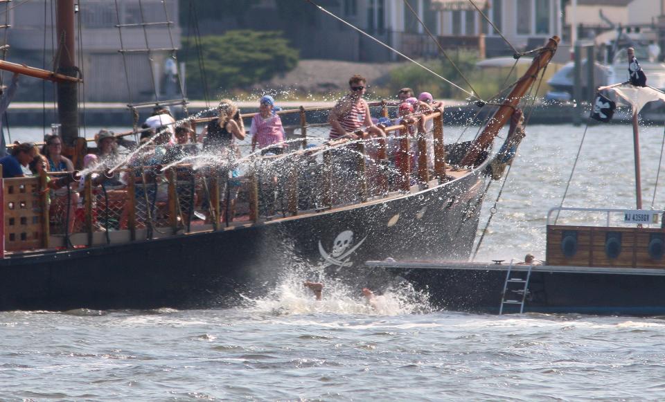 Pirate Adventures Jersey Shore participants fire water cannons at another pirate in the Metedeconk River off Windward Beach in Brick Township Thursday, August 4, 2022.