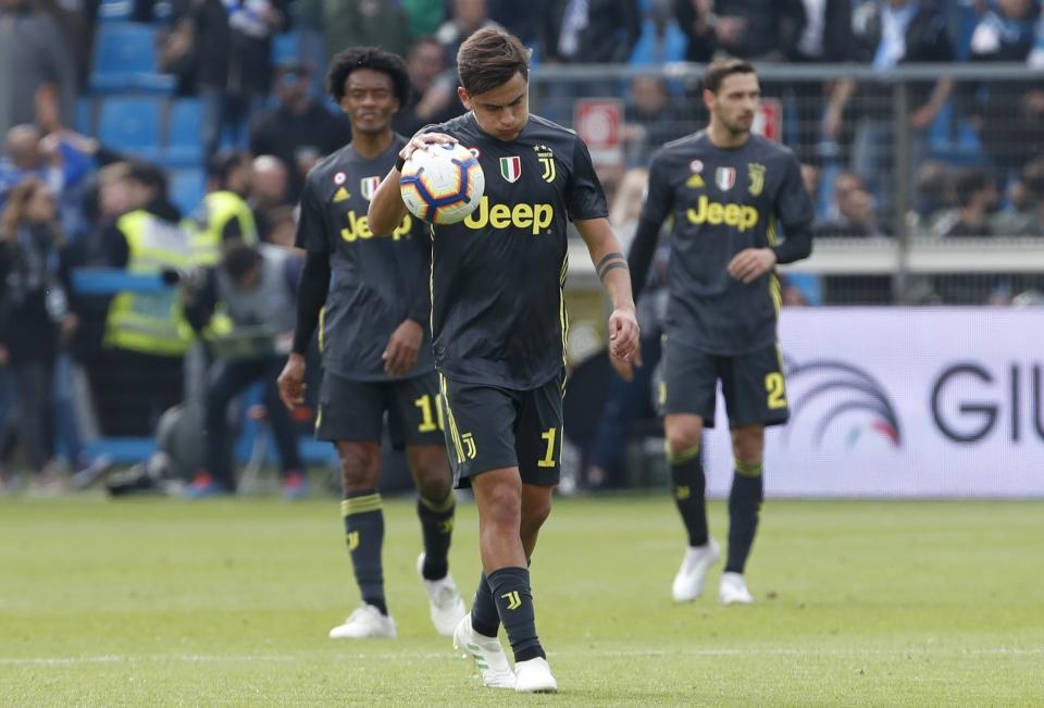 Juventus' Paulo Dybala walks with the ball after Spal's Sergio Floccari scored his side's 2nd goal during the Serie A soccer match between Spal and Juventus, at the Paolo Mazza stadium in Ferrara, Italy, Saturday, April 13, 2019. (AP Photo/Antonio Calanni)