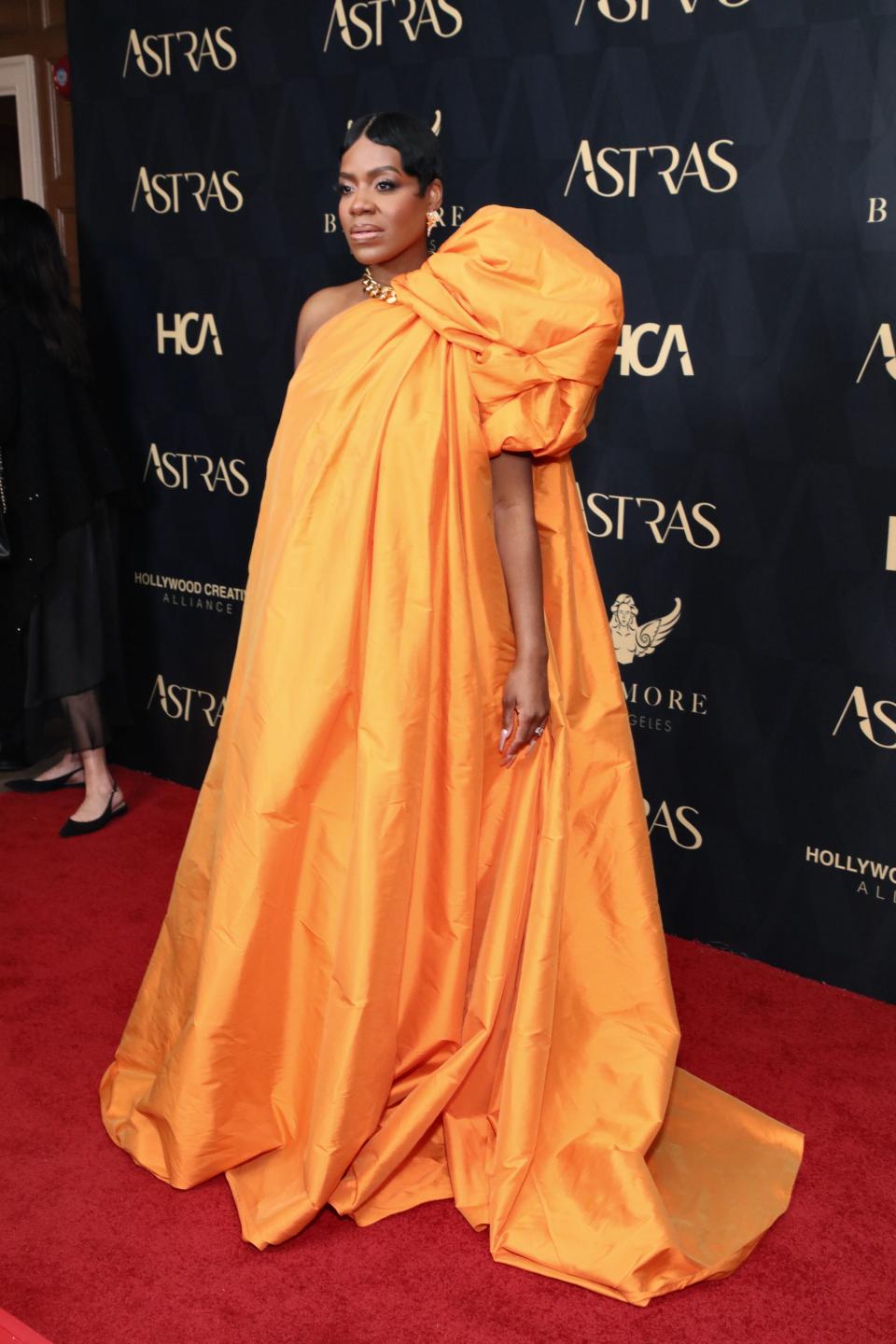 Fantasia Barrino wears orange gown in January 2024.