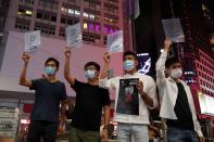 FILE PHOTO: Activists Eddie Chu, Joshua Wong, Owen Chow and Lester Shum pose with signs in support of the 12 Hong Kong activists held in mainland China after attempting to flee the city for Taiwan, in Hong Kong