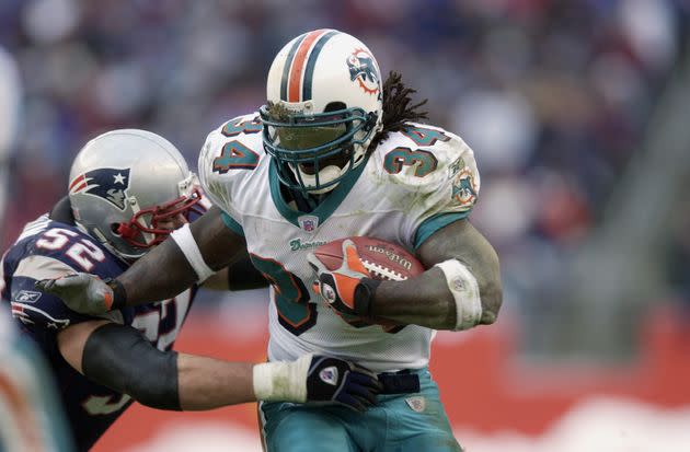 Ricky Williams carries the ball for the Miami Dolphins during the 2002 season in which he rushed for a career-high 1,853 yards. (Photo: Ezra Shaw via Getty Images)