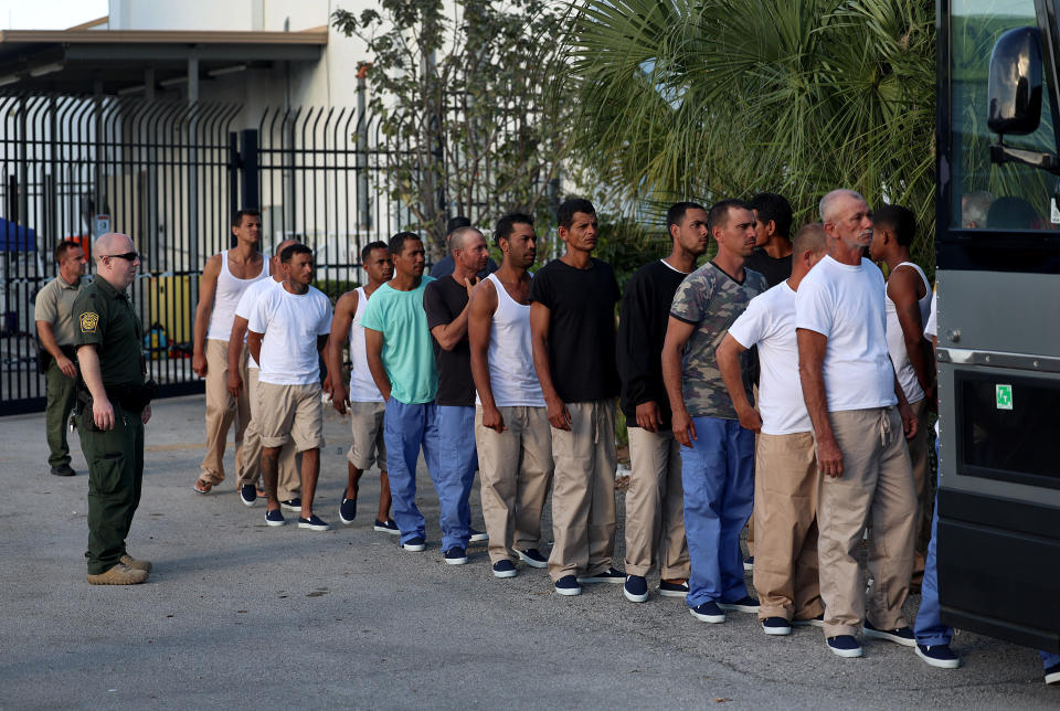 Migrants from Cuba line up to board a bus to be driven to a U.S. Customs and Border Protection station